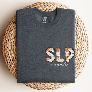 a t - shirt with the word slp printed on it