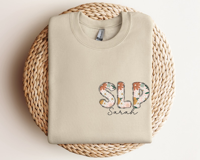 a white t - shirt with the word sls on it