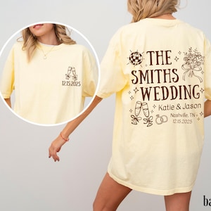 A woman wearing a yellow t-shirt with text and graphics printed on it.