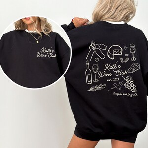 a woman wearing a black sweatshirt and shorts