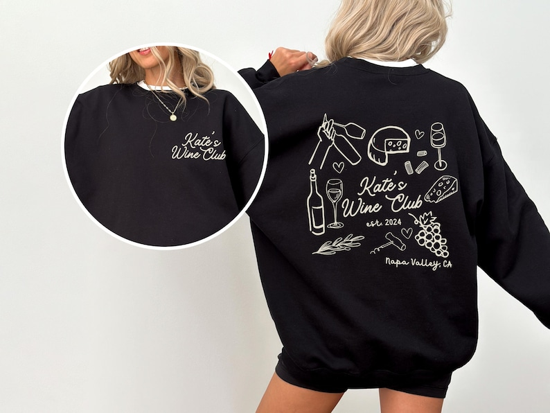 a woman wearing a black sweatshirt and shorts