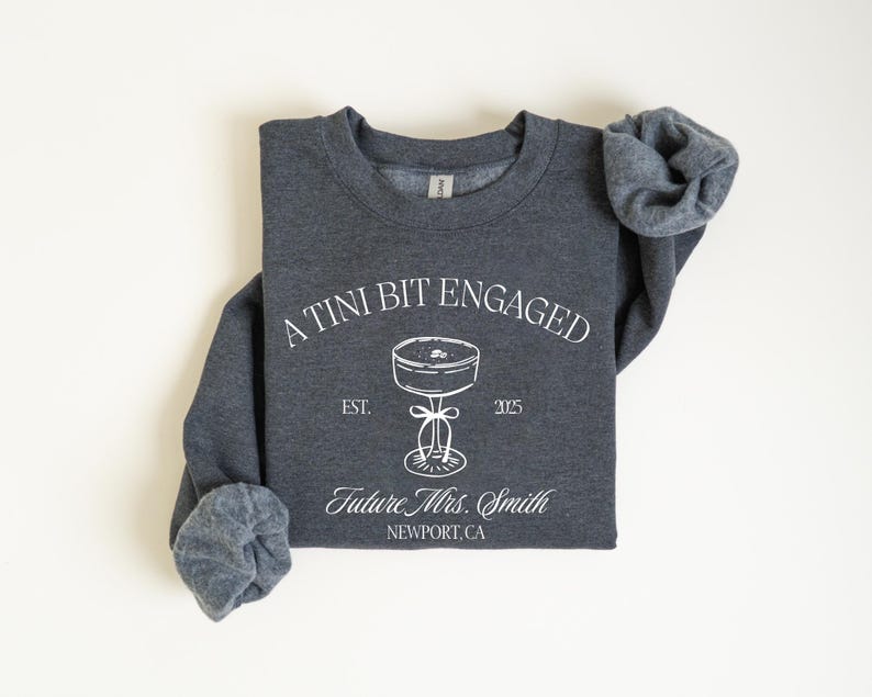 A gray sweatshirt with white text and graphics printed on it.