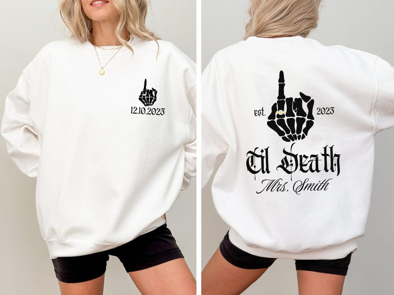 A white sweatshirt with black text and graphics on the back.