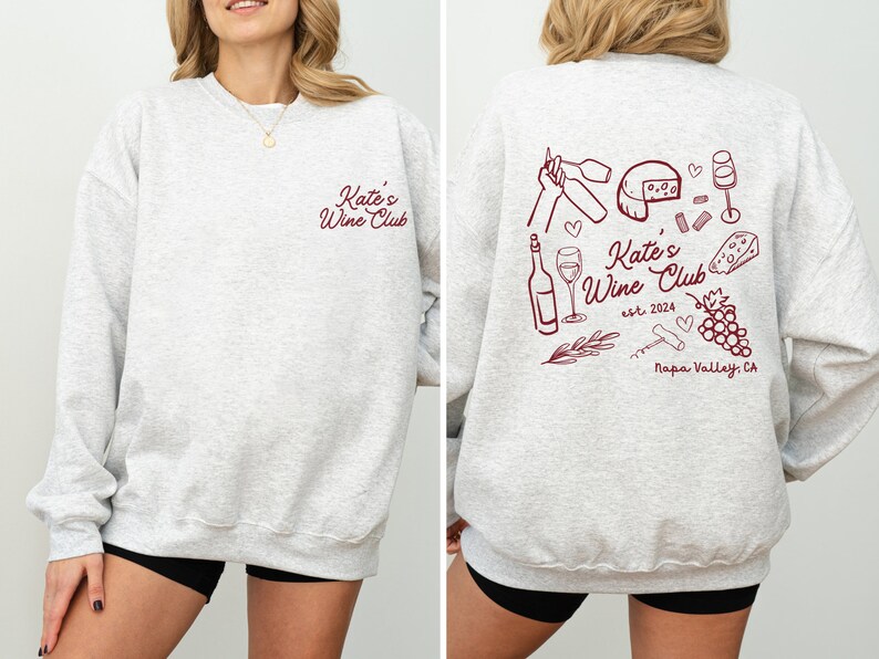 a woman wearing a sweatshirt with wine related items on it
