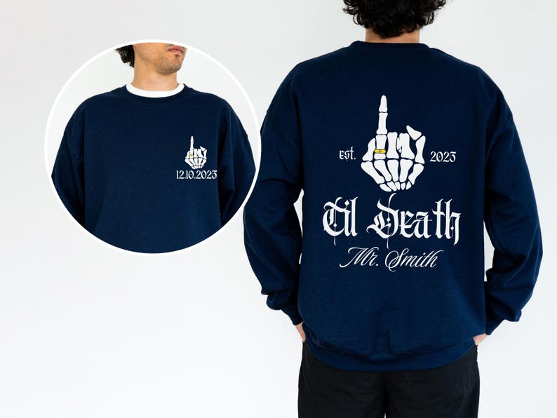 A man wearing a navy blue sweatshirt with white text and graphics on the back.
