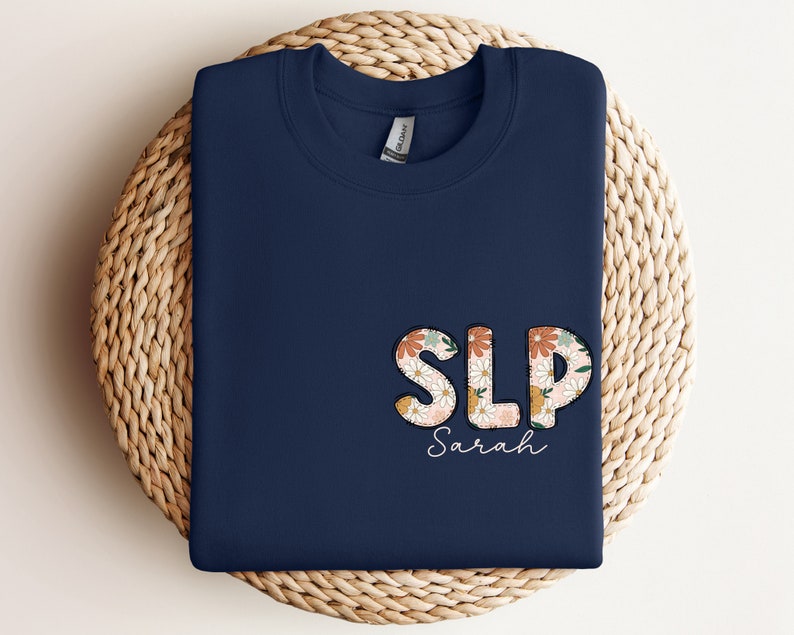 a blue shirt with the word slp on it