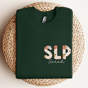 a green shirt with the word slp on it