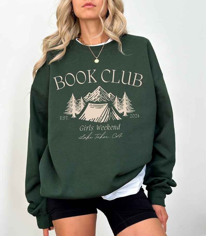 a woman wearing a green book club sweatshirt