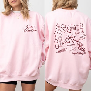 a woman wearing a pink sweatshirt and shorts