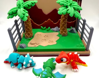 May include: A colorful dinosaur playset featuring a green, brown, and tan backdrop with two green palm trees and a green base. Includes a blue triceratops, a green dragon with blue wings, and a red dinosaur with yellow accents.