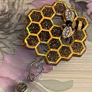 Honeycomb badge reel with  glitter background and bee charm