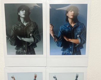 May include: Four Polaroid photos of a person wearing a denim jacket and jeans. The person is posing in different ways, including with their arms crossed, with their arms raised in the air, and with their torso exposed.