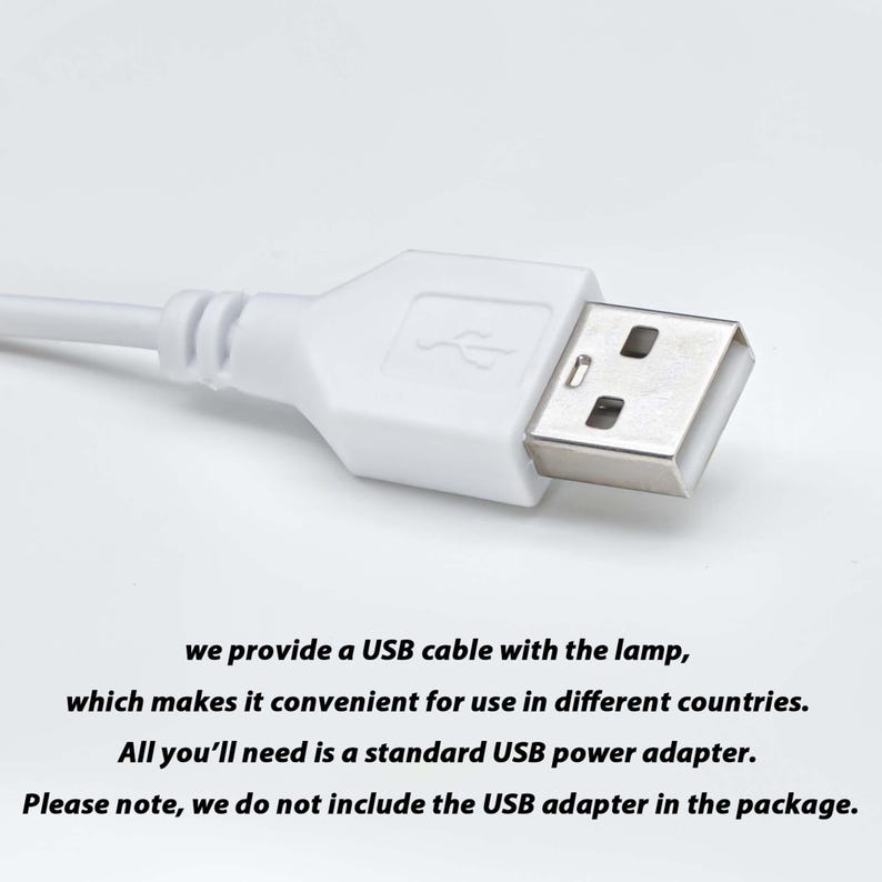 May include: A white USB cable with a standard USB connector. The text on the image reads: "we provide a USB cable with the lamp, which makes it convenient for use in different countries. All you'll need is a standard USB power adapter. Please note, we do not include the USB adapter in the package."