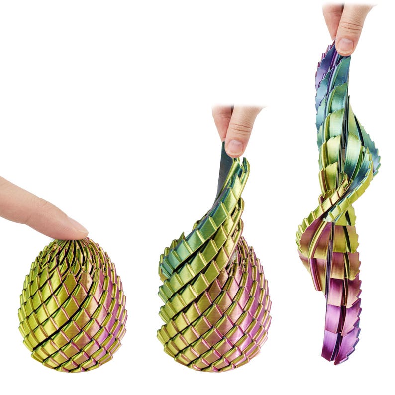 May include: A metallic, iridescent egg-shaped sculpture is shown in three stages of manipulation. The sculpture is made of interlocking segments that can be flexed and extended. Colors include green, gold, and purple.