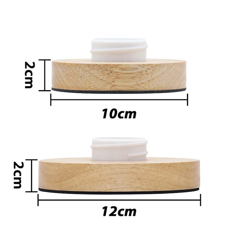 May include: Two wooden round bottle stoppers with a white plastic top. The larger stopper measures 12 cm in diameter and the smaller stopper measures 10 cm in diameter. Both stoppers are 2 cm in height.