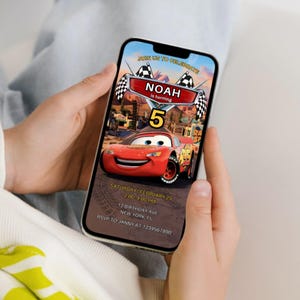 May include: A smartphone displays a birthday invitation featuring a red cartoon race car. The invitation reads "NOAH is turning 5" with event details: Saturday, February 25, 2:00-4:00 PM, 12 Birthday Ave, New York, FL. RSVP to Janny at 1234567890.