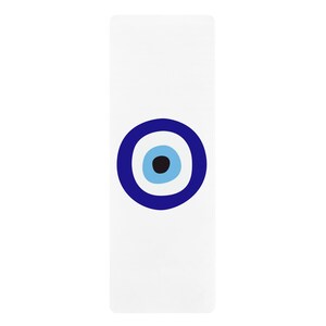 May include: A white yoga mat with a blue and white evil eye design.