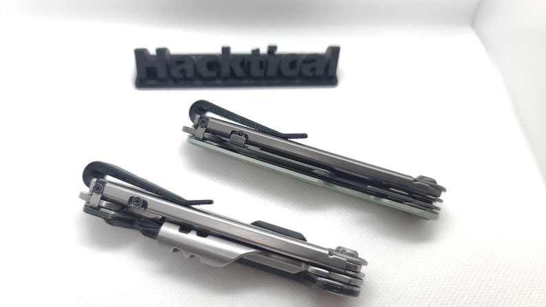 Puede incluir: Dos navajas multiusos de bolsillo con mangos negros y hojas plateadas. Las navajas est&aacute;n cerradas y tienen un clip en el mango.