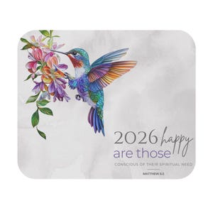 May include: A square coaster featuring a colorful hummingbird with outstretched wings, feeding from a cluster of flowers. The coaster has the text "2026 happy are those" and a Bible verse.
