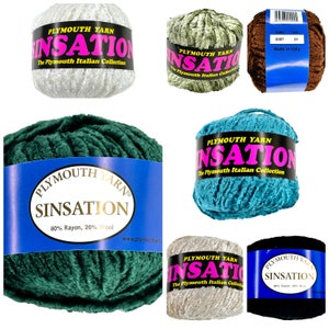 May include: Assortment of six skeins of Plymouth Yarn Sinsation yarn in various colors, including teal, green, brown, and white. The yarn is made of 80% rayon and 20% wool.