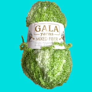 May include: A skein of green and white mixed fibre yarn with a label that reads "Gala Yarns Mixed Fibre Acrylic, Polyester Acrilico, Poliester".