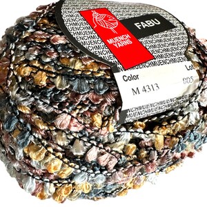 May include: A ball of yarn with a multi-coloured, textured, fuzzy look. The yarn is wrapped around a label that says "Muench Yarns" and "Fabu". The label also has the colour code "M 4313" and the lot number "005".