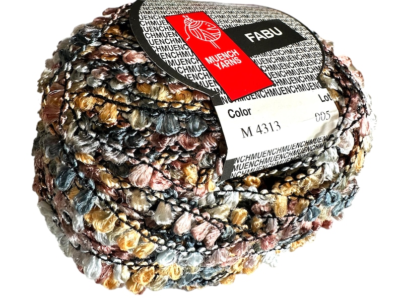 May include: A ball of yarn with a multi-coloured, textured, fuzzy look. The yarn is wrapped around a label that says "Muench Yarns" and "Fabu". The label also has the colour code "M 4313" and the lot number "005".