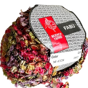 May include: A skein of multi-coloured yarn with a label that reads "FABU" and "MUENCH YARNS". The label also includes the colour code "M 4328" and the lot number "002".