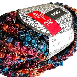 May include: A skein of multicolored yarn with a label that reads "FABU" and "MUENCH YARNS". The label also includes the color code "M 4304" and the lot number "007".