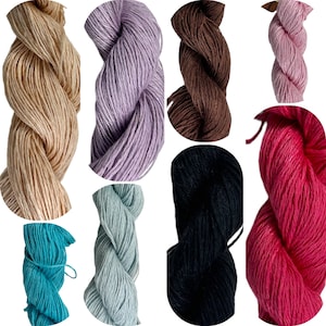 May include: Assortment of ten skeins of yarn in various colors, including beige, lavender, brown, black, teal, and pink.