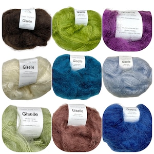 May include: Nine skeins of Giselle yarn in various colors, including brown, green, purple, white, teal, blue, light blue, brown, and green. The yarn is a blend of kid mohair, wool, and nylon. The label reads "Classic Elite Yarns Giselle 64% kid mohair, 25% wool, 11% nylon".