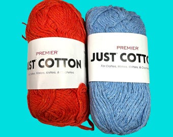 May include: Two skeins of Premier Just Cotton yarn, one in a bright orange color and the other in a light blue color. The yarn is for crafters, makers, knitters, and crocheters.