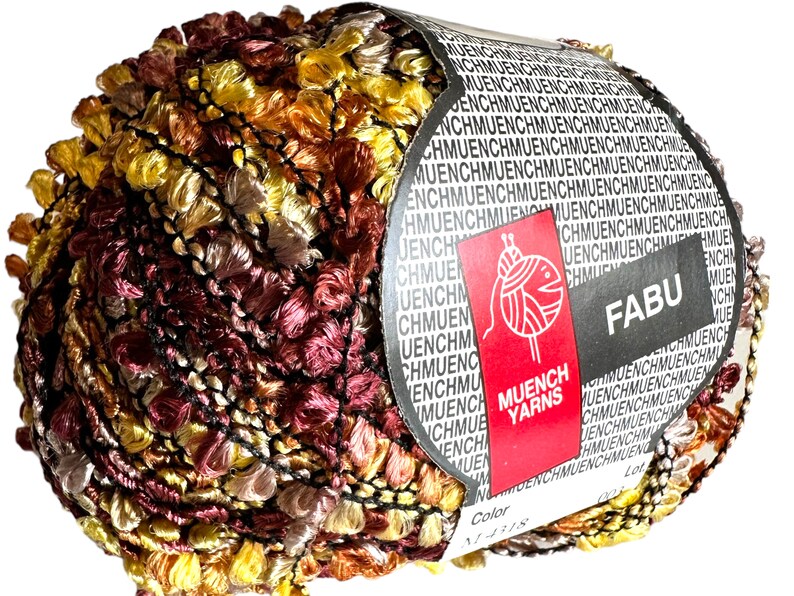 May include: A ball of yarn in shades of brown, orange, and yellow with a black and white pattern. The yarn is labeled "FABU" and "MUENCH YARNS".
