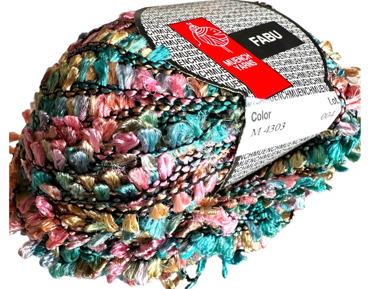 May include: A skein of multi-colored yarn with a label that reads "FABU MUENCH YARNS" and "Color M 4303".