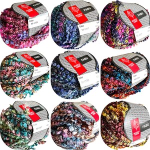 May include: Nine balls of yarn in various colors, including pink, blue, green, and brown. Each ball has a label with the brand name "MUENCH YARNS" and the text "FABU".