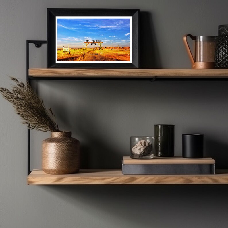 May include: A framed photograph of a sign that reads "Double Six Ranch" with a blue sky and a dirt road leading to the sign.