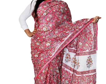 May include: A pink and white cotton saree with a floral print. The saree has a white border with a floral design.