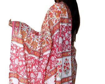 May include: A white and pink cotton saree with a floral print. The saree has a red border with a white and orange floral design.