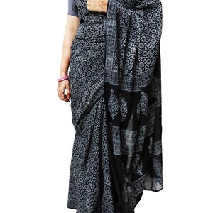 May include: A black and white cotton saree with a floral print. The saree has a border with a paisley design.