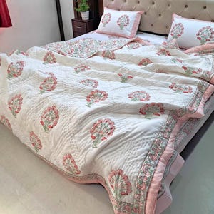 Indian handmade cotton comforter with traditional block print floral pattern and quilted texture