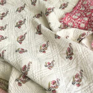 Vintage floral pink cotton quilt with hand block printed botanical pattern, reversible cotton throw blanket, cottagecore bedspread, boho bedding, handmade Indian quilt in soft pink tones.