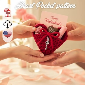 May include: A red crocheted heart-shaped pocket with a bow and key charm, holding a Valentine's Day card, a rose, a chocolate heart, and a lip balm. The card reads "Happy Valentine's". The image is of a craft project.