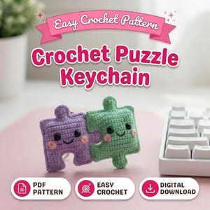 May include: Crochet Puzzle Keychain pattern. The image shows two crocheted puzzle pieces, one purple and one green, with smiling faces and pink cheeks. The text "Easy Crochet Pattern" and "Crochet Puzzle Keychain" is displayed above the keychains.