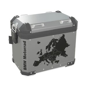 May include: A rectangular silver aluminum motorcycle side case with black corner protectors and metal latches. The side features a black silhouette map of Europe and the text BMW Motorrad printed vertically in black lettering on the left side.