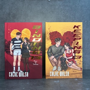 May include: Two hardcover books with illustrated covers. The book on the left has a red background with two figures and the title "Blind". The book on the right has a yellow background with two figures and the title "Keep Me". Both books are by Chloe Walsh.