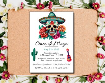 May include: A white invitation card with a colorful illustration of a sugar skull wearing a sombrero. The text reads "Cinco de Mayo" and "May 5th 2023". The invitation details a Mexican Fiesta with food and drinks.