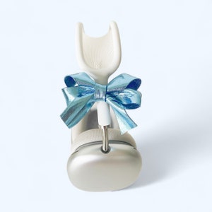 May include: White headphones with a light blue bow on the headband.