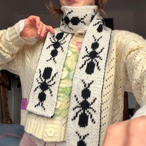 May include: A set of three ceramic mugs with a speckled, matte finish. The mugs are in shades of cream, light gray, and dark gray. Each mug has a simple, minimalist design and a rounded handle. Perfect for coffee or tea.