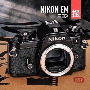 May include: A black Nikon EM 35mm film camera body featuring a textured grip, a silver lens mount, and a top-mounted film advance lever. The camera displays the Nikon logo on the front prism housing and an EM badge above the lens mount.