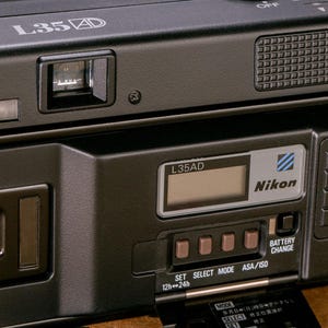 Back view of the Nikon L35AD (Pikaichi) film camera, showing the Quartz Date LCD screen and control buttons.